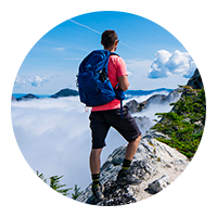 young man hiking on mountain button